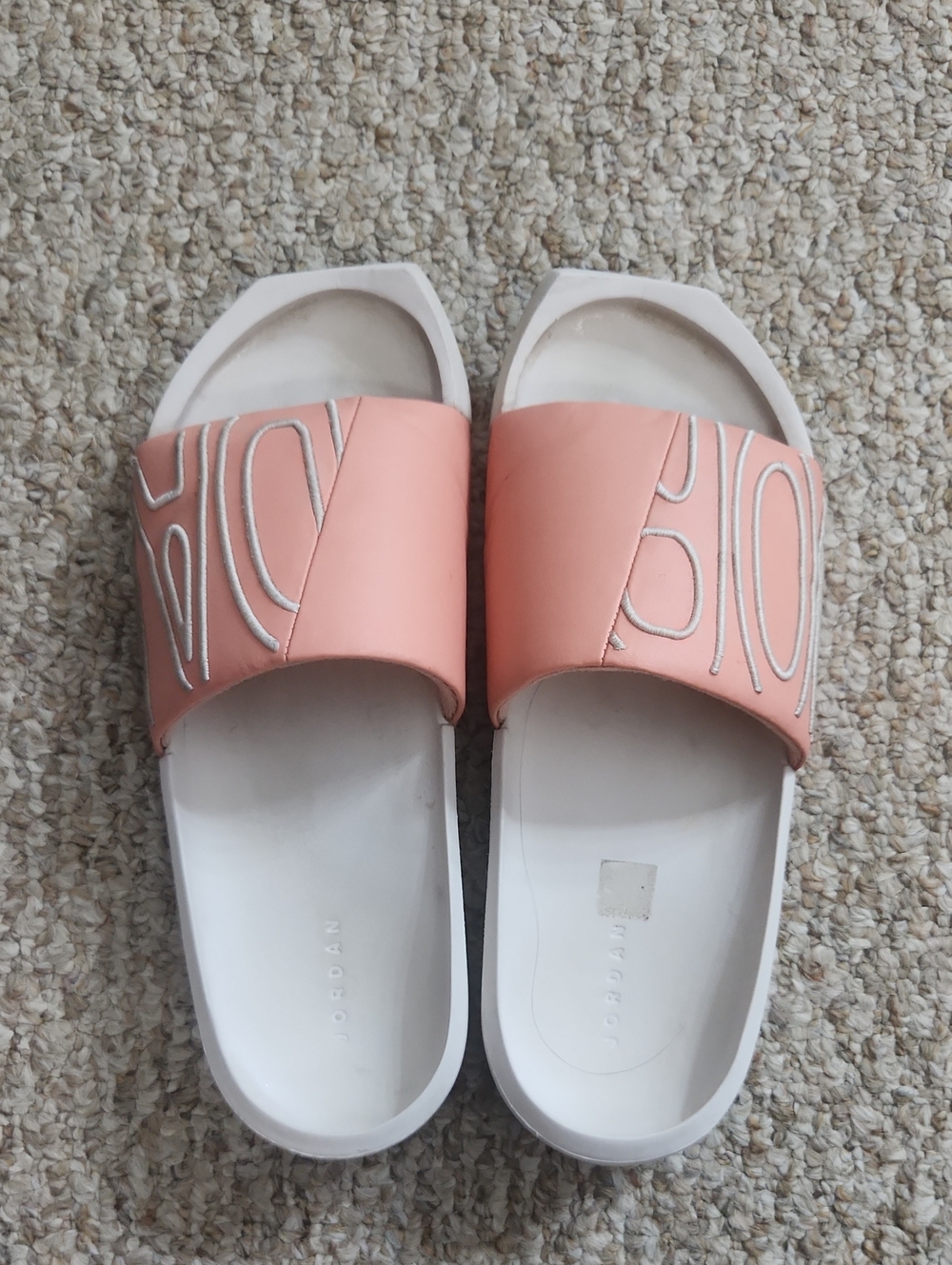 Jordan Women’s Coral Pink Slide Sandals with Embossed Strap